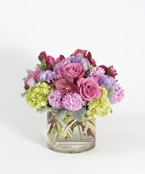 monochromatic arrangement of purple sweet pea, tulips, and hyacinth