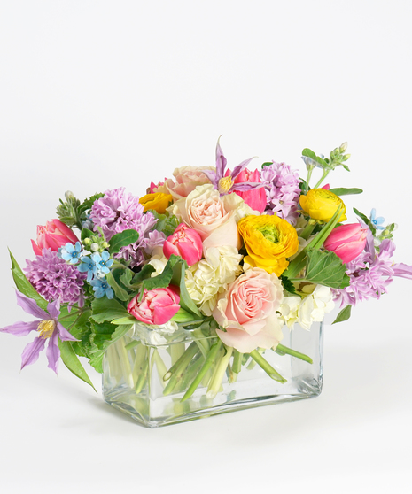 rectangular spring floral centerpiece with pink, peach, and lavender blooms