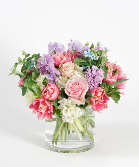 spring floral design of pink tulips, lavender sweet pea and peach roses