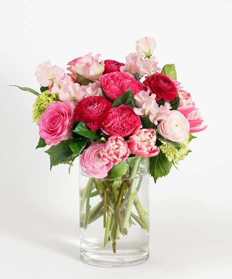 romantic floral design of pink, soft pink, and hot pink tones featuring roses, ranunculus, tulips and sweet pea